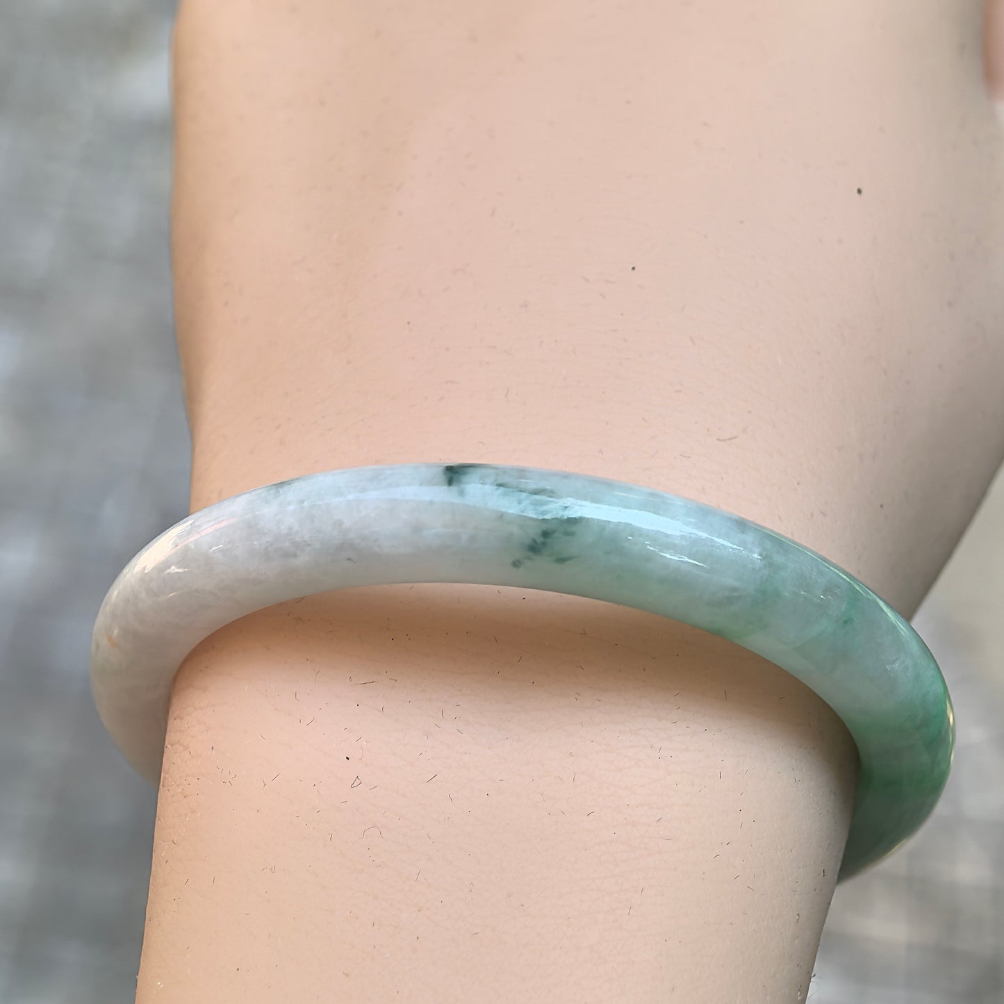Close-up of the vivid green area on the natural Burmese jadeite bangle.