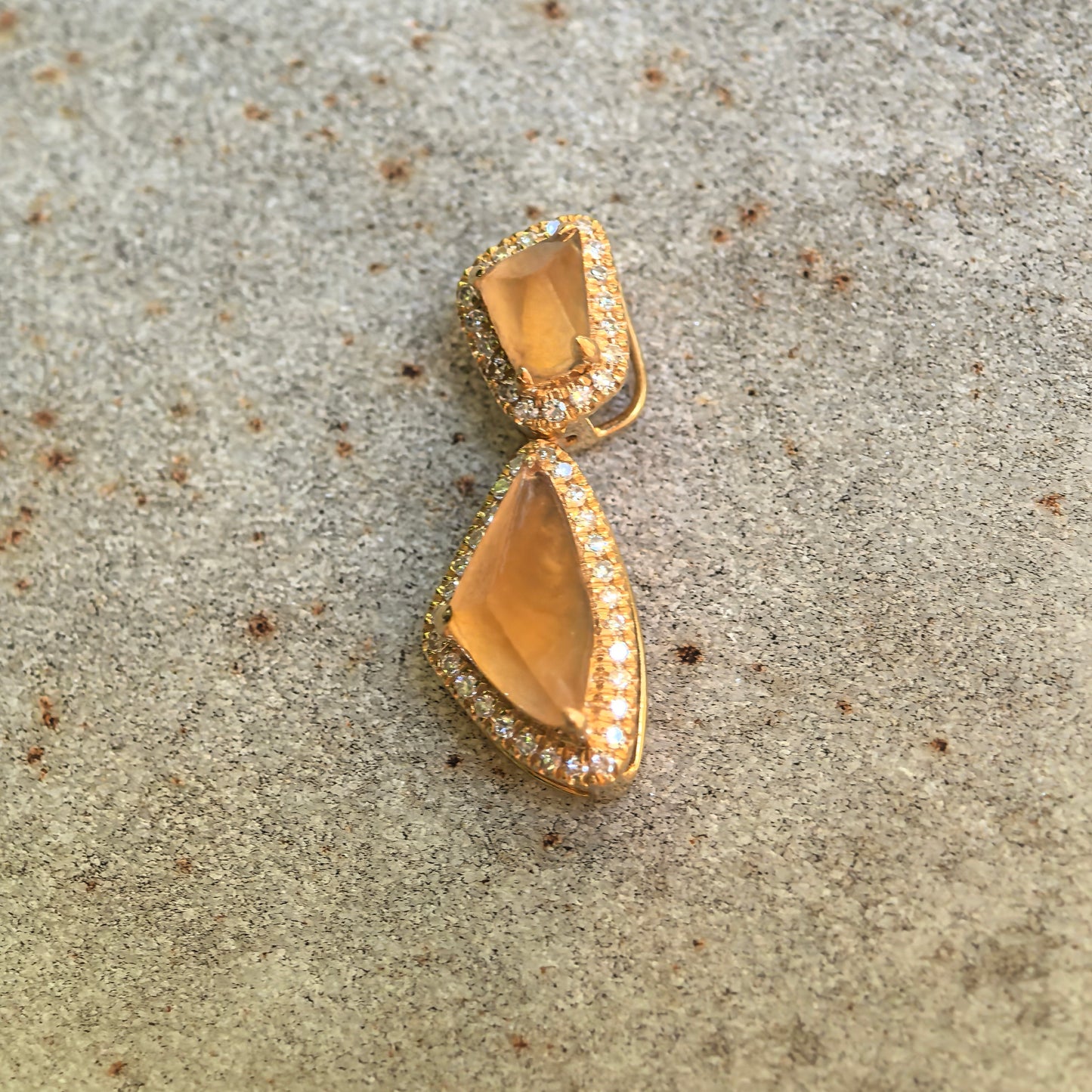 Front detail of the golden yellow freeform jadeite pendant showing its vivid color, translucency, and articulated structure.