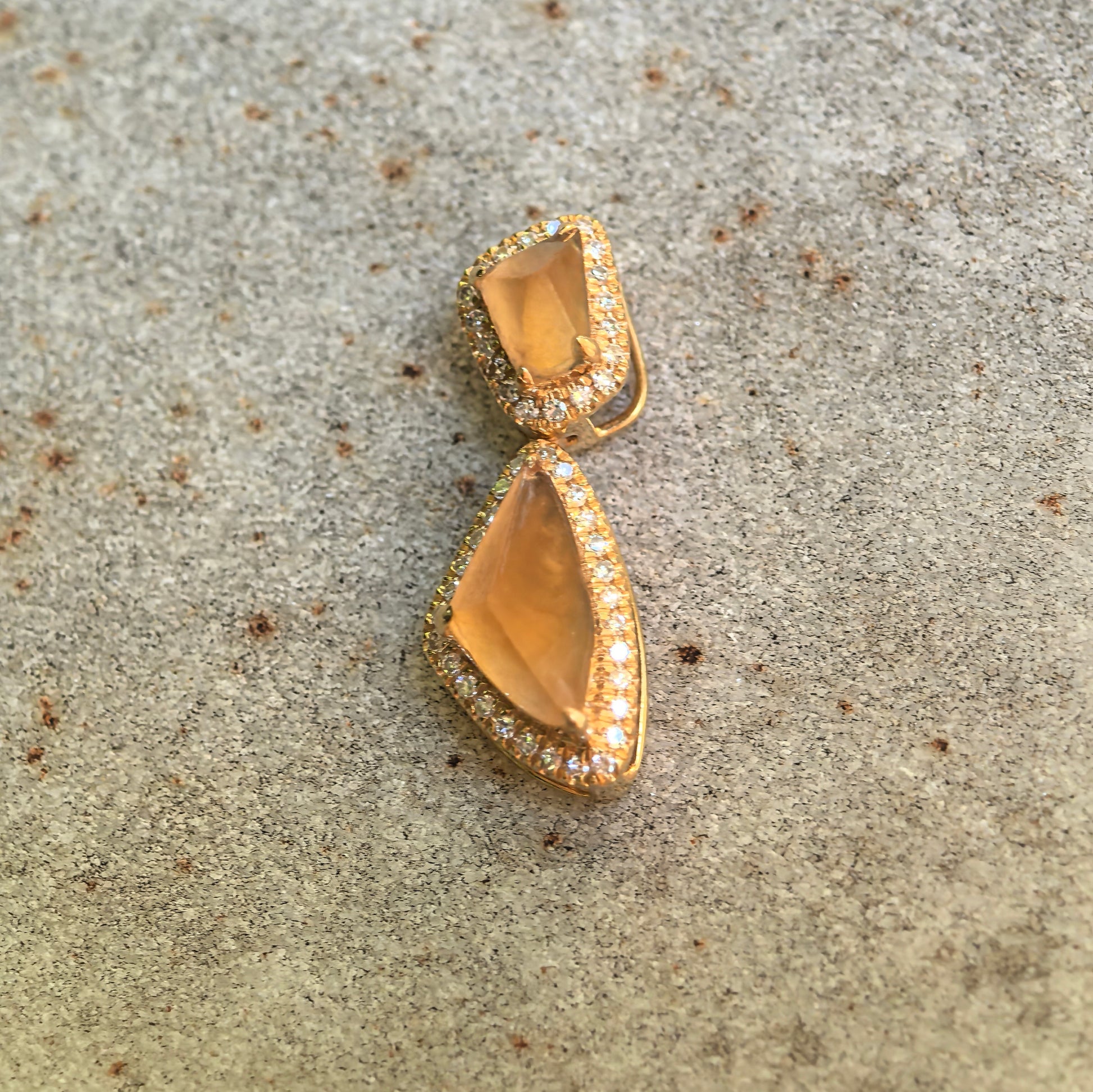 Front detail of the golden yellow freeform jadeite pendant showing its vivid color, translucency, and articulated structure.