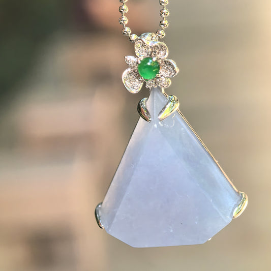 Natural Grade-A icy glutinous lavender triangular jadeite pendant with an 18K white gold floral bail, diamonds, and green jadeite accent.