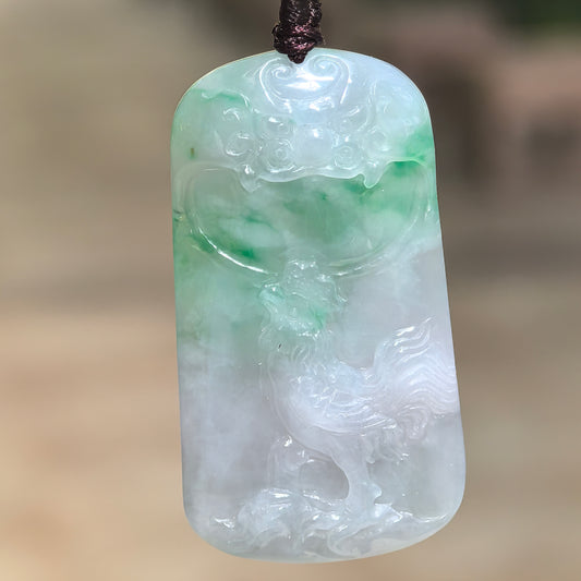 Natural Grade-A glutinous white-and-green rooster plaque jadeite pendant hanging from its cord and showing detailed relief carving.