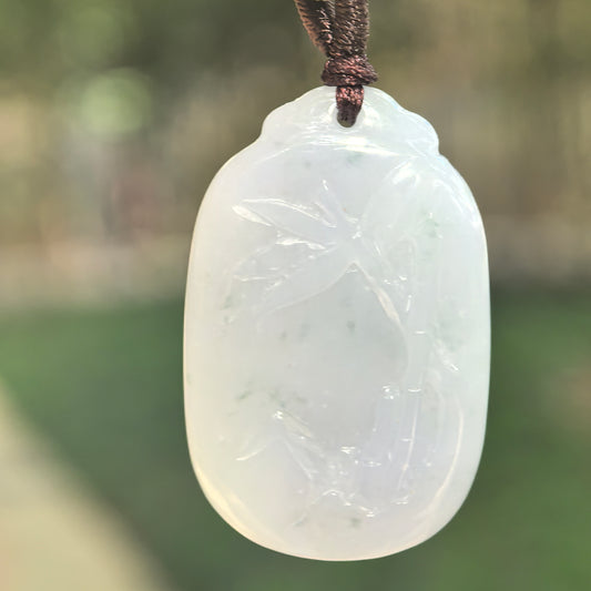Natural Grade-A glutinous pale lavender bamboo jadeite pendant hanging from a brown cord.