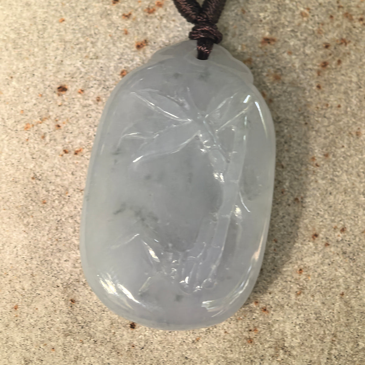 Front detail view of the natural jadeite bamboo pendant with subtle light green accents and soft translucency.
