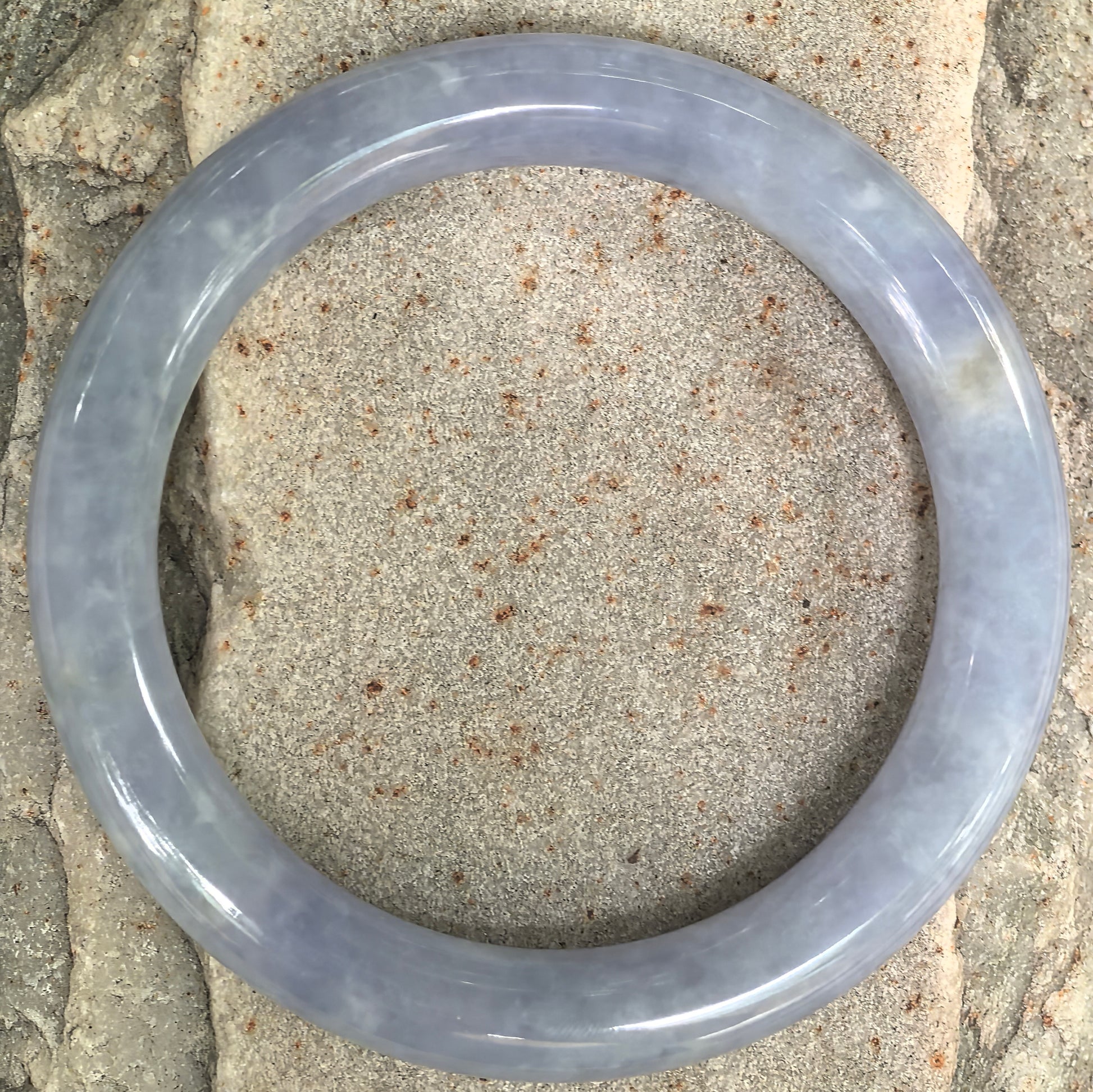 Top view of natural Grade-A blue-lavender Burmese jadeite round bangle showing its full circular profile and glutinous texture.