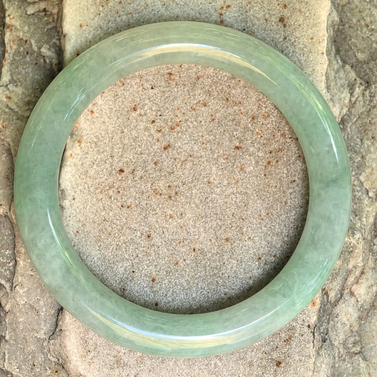 Top view of the icy glutinous mint green Burmese jadeite round bangle showing its full circular form.