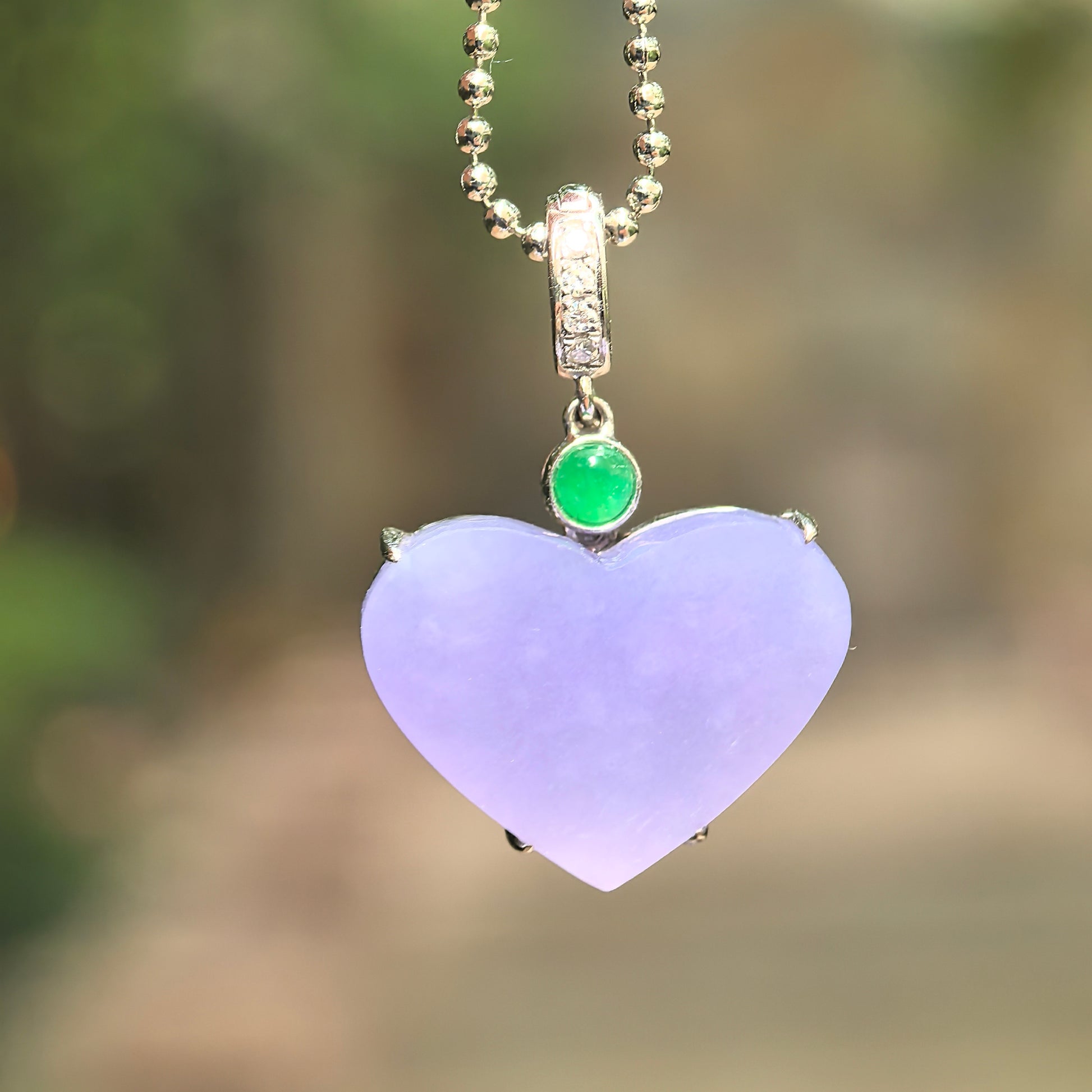 Natural Grade-A glutinous lavender heart jadeite pendant with 18K gold setting and green jade accent.
