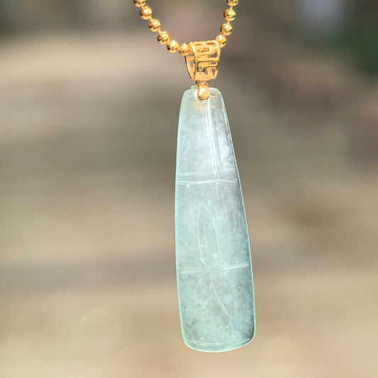 Natural Grade-A icy light green bamboo jadeite pendant hanging from a chain, showing its slender carved bamboo segment design.