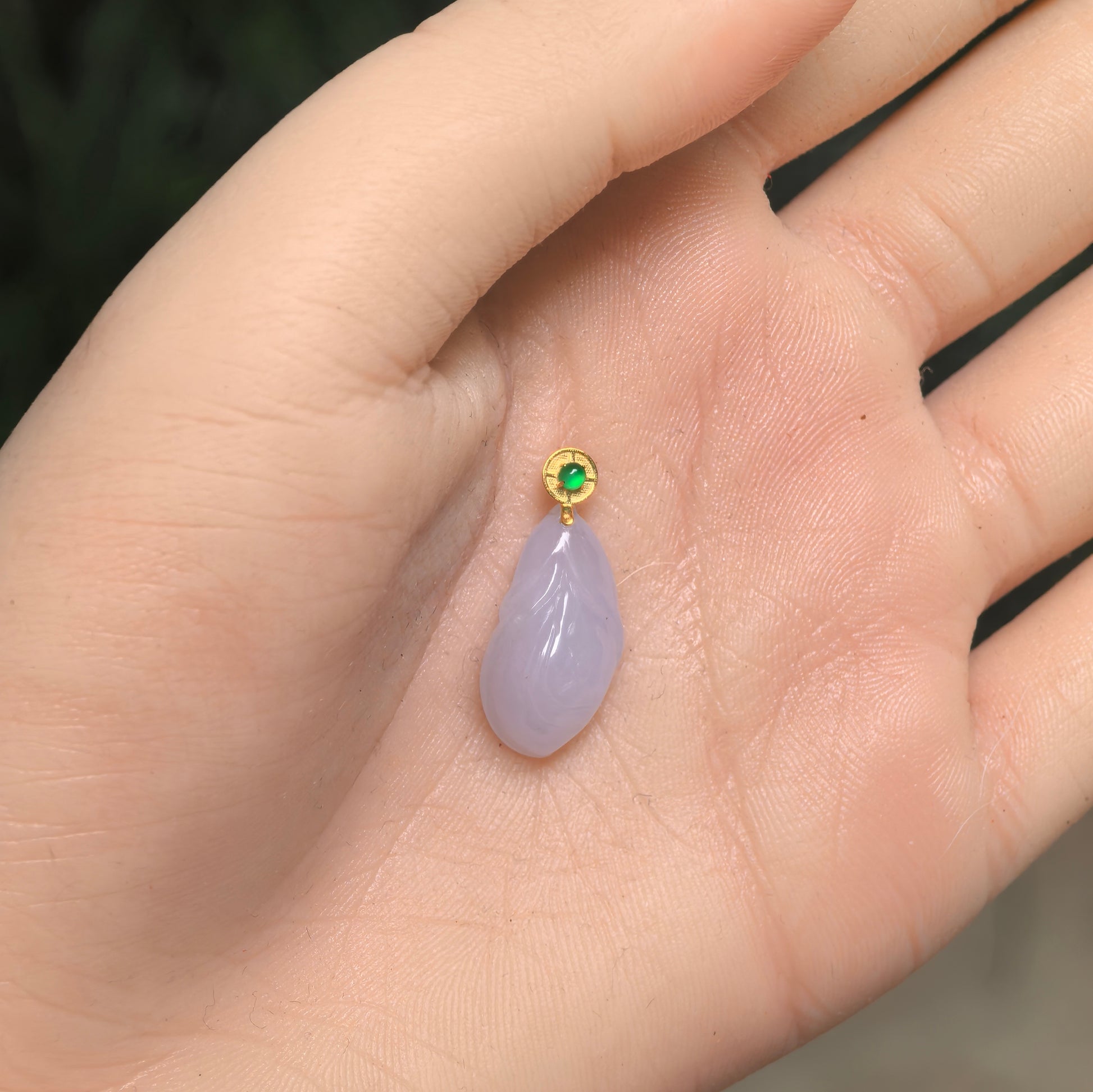 Natural Grade-A icy glutinous lavender magnolia jadeite pendant shown in hand for scale with 18K gold bail.