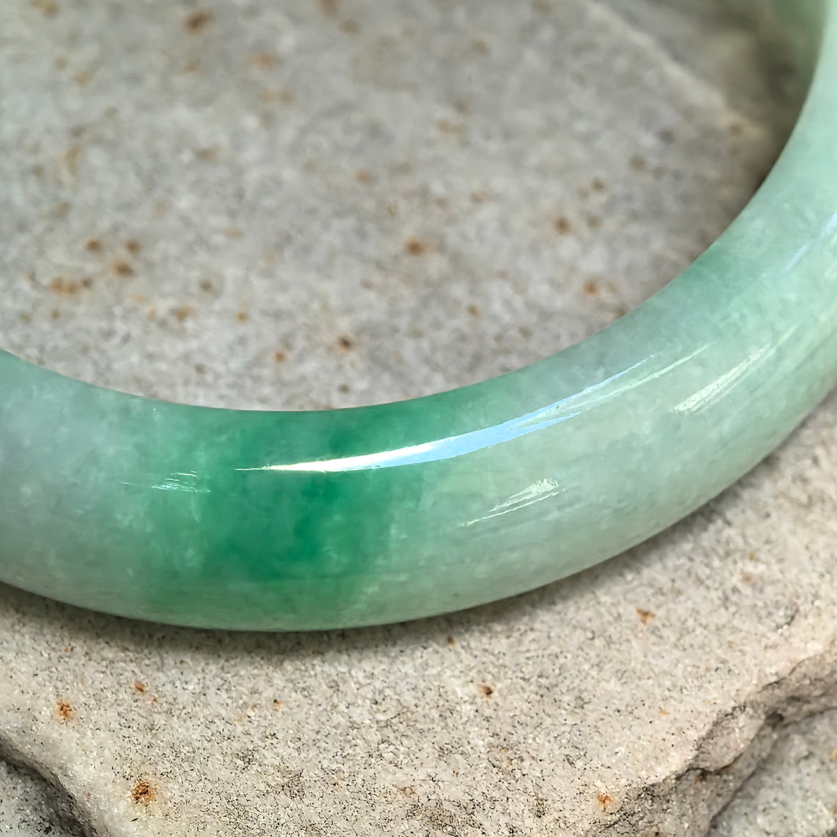 Glutinous White-Base Green Oval Jadeite Bangle – 53mm