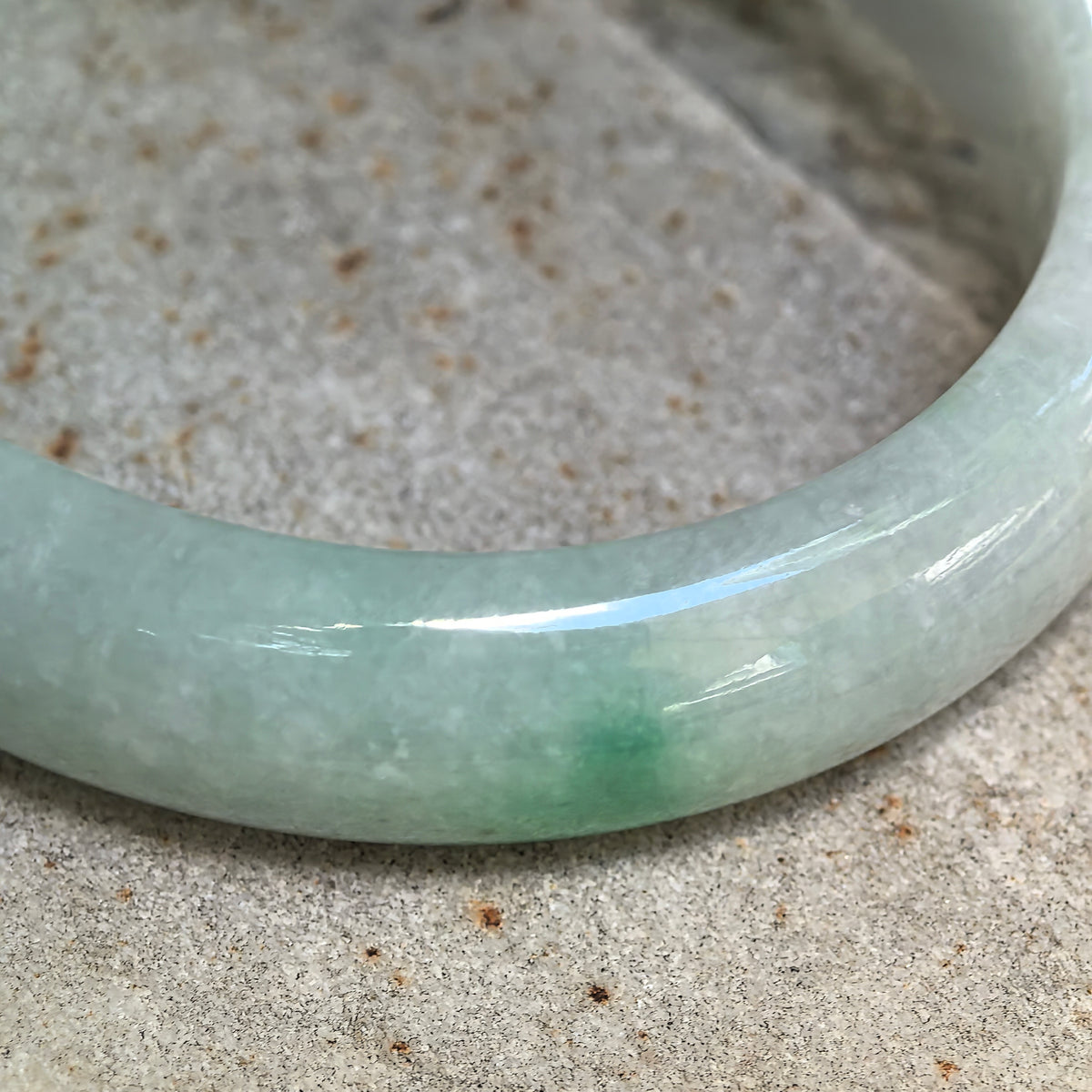 Glutinous White-Base Green Oval Jadeite Bangle – 53mm