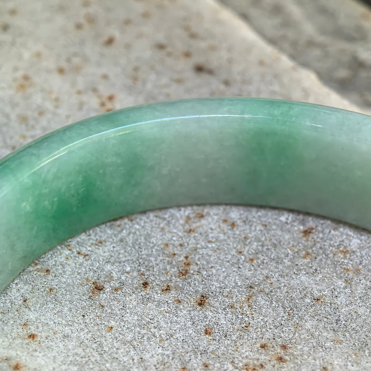 Glutinous White-Base Green Oval Jadeite Bangle – 53mm
