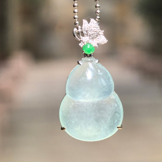 Icy light green jadeite Gourd Pendant hanging from a bead-style chain, with an 18K gold setting, diamond butterfly detail and round green accent stone.