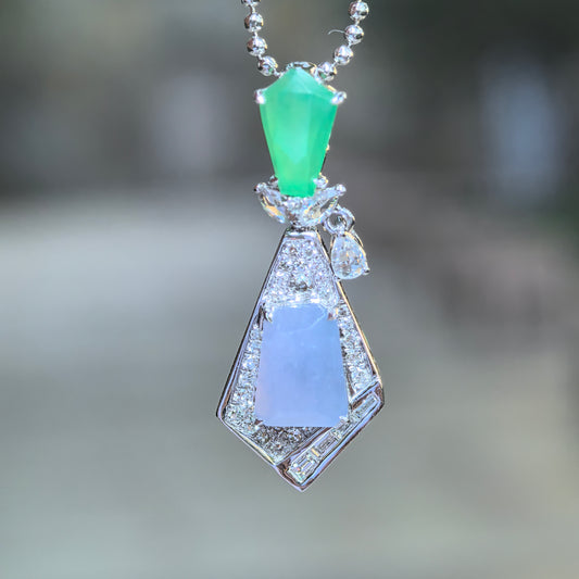 Lavender and green jadeite geometric kite-shaped pendant hanging from a bead chain, showing its diamond frame and small dangling side detail.