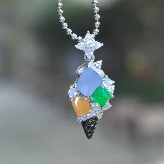 Multicolor jadeite ice cream cone pendant hanging from a bead chain, showing pale lavender, green and brownish yellow jadeite with diamond accents and a black pointed cone.