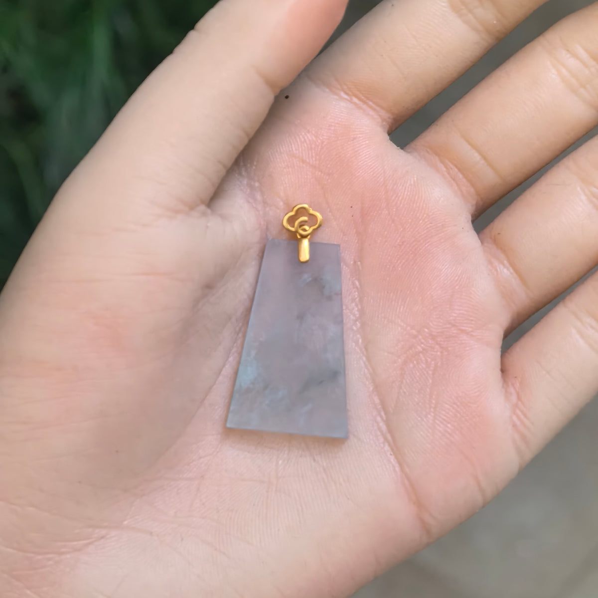 Icy pale blue jadeite Plain Plaque Pendant resting on a palm, with cotton-like inclusions and an 18K gold cloud-shaped bail.