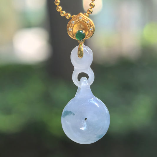 Icy purple jadeite Peace Pendant hanging from a chain, showing integral jadeite links, green patches, and an 18K gold bail with diamonds.