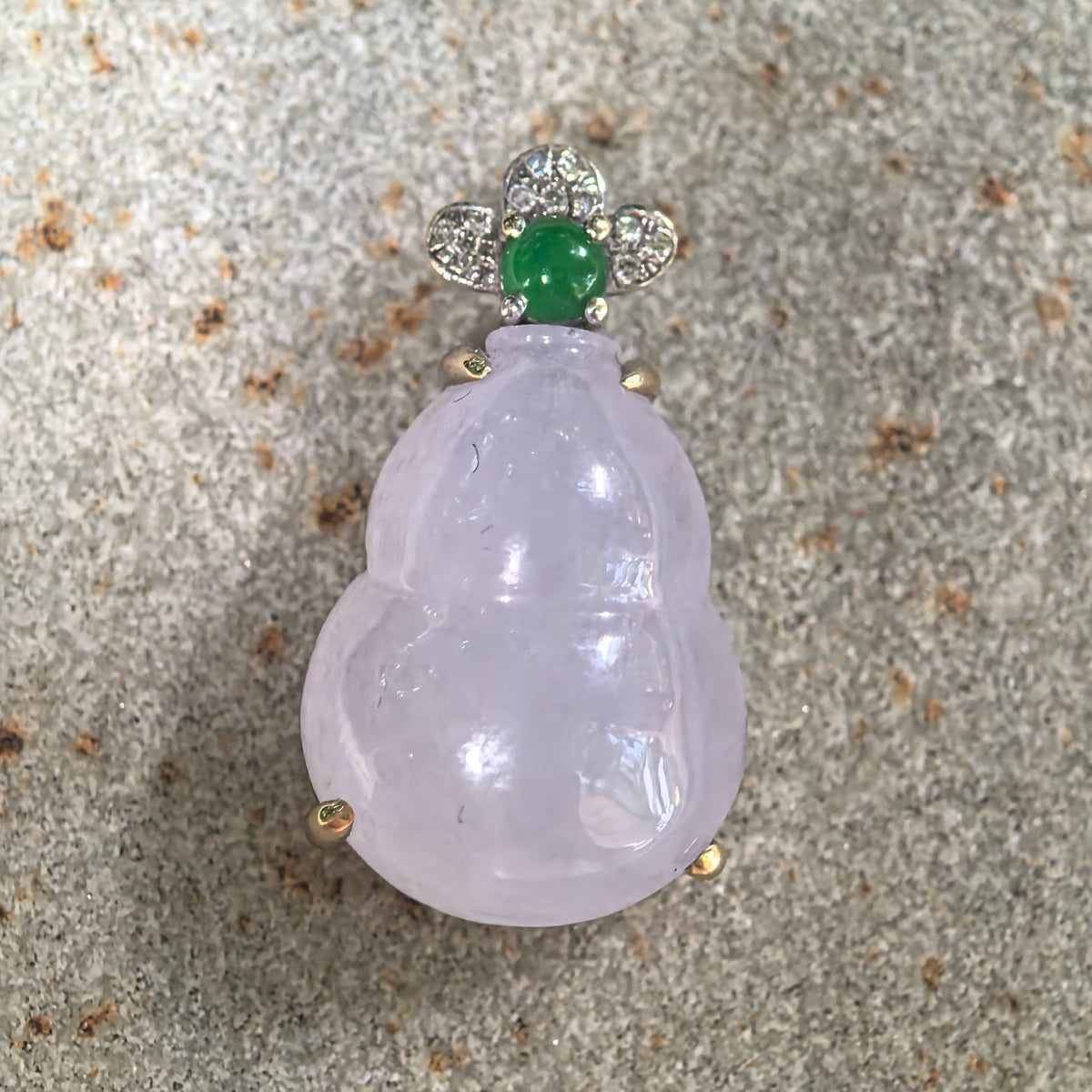 Front close-up of the purple jadeite Gourd Pendant on stone, showing its defined waist and floral arrangement of diamonds around a green accent stone.